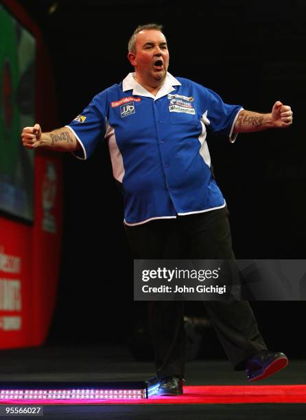 Phil Taylor of England celebrates a point in the game against Simon Whitlock of Australia during the Final of the Ladbrokes.com World Darts...