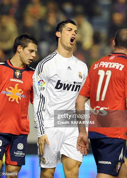 Real Madrid's Portuguese forward Cristiano Ronaldo reacts after missing a goal against Osasuna during a Spanish league football match, on January 3...
