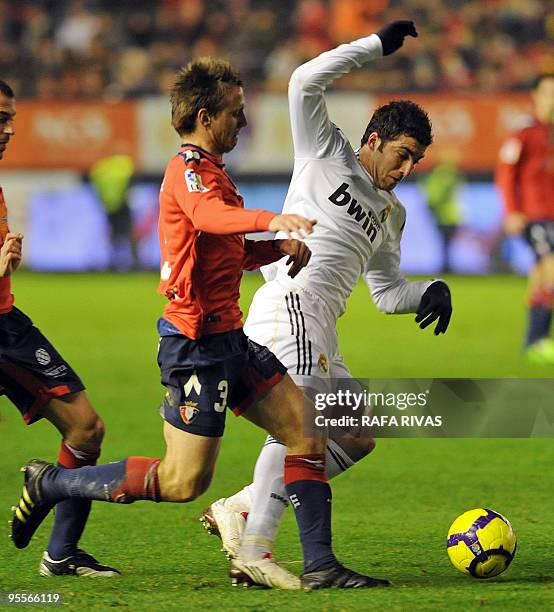 Osasuna's Ignacio Monreal vies with Real Madrid's Argentinian forward Gonzalo Higuain during a Spanish league football match, on January 3 at Reyno...
