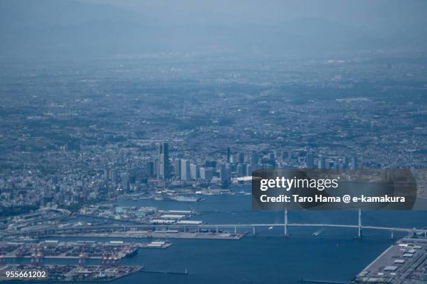 yokohama minato mirai area, yokohama harbor and yokohama bay bridge in yokohama city in japan daytime aerial view from airplane - yokohama bay bridge stock pictures, royalty-free photos & images