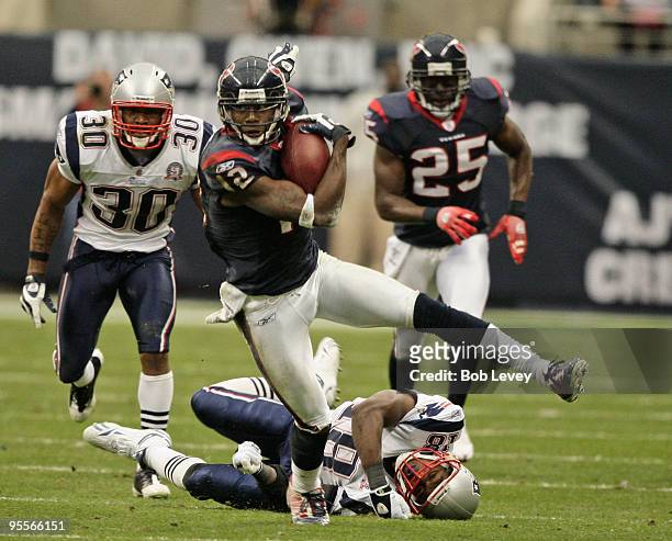 Kick returner Jacoby Jones of the Houston Texans avoids a tackle from Brandon McGowan and Matthew Slater of the New England Patriots at Reliant...