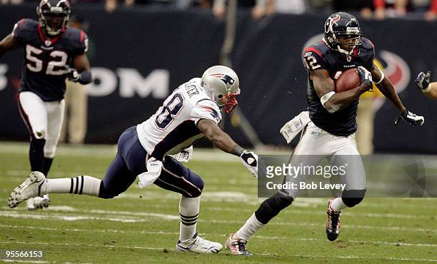 Kick returner Jacoby Jones of the Houston Texans avoids a tackle from Matthew Slater of the New England Patriots at Reliant Stadium on January 3,...