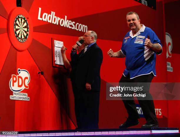 Phil Taylor of England celebrates a point in the game against Simon Whitlock of Australia during the Final of the Ladbrokes.com World Darts...