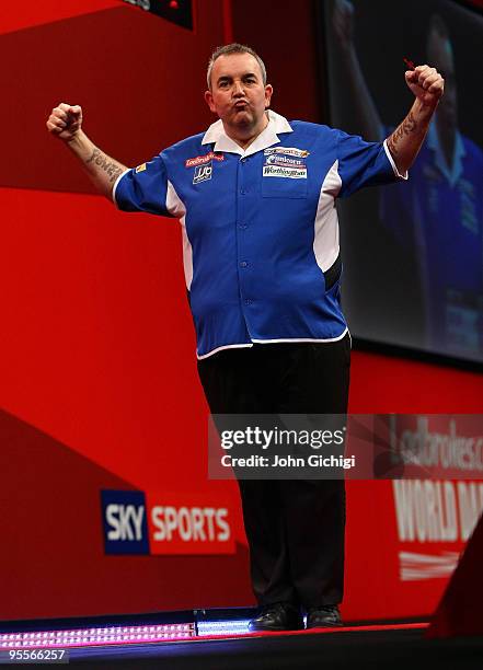 Phil Taylor of England celebrates a point in the game against Simon Whitlock of Australia during the Final of the Ladbrokes.com World Darts...