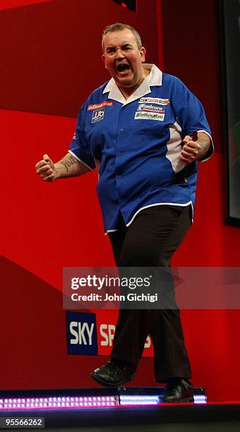 Phil Taylor of England celebrates a point in the game against Simon Whitlock of Australia during the Final of the Ladbrokes.com World Darts...