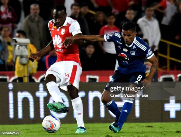 Baldomero Perlaza of Independiente Santa Fe fights for the ball with César Carrillo of Millonarios a match between Independiente Santa Fe and...