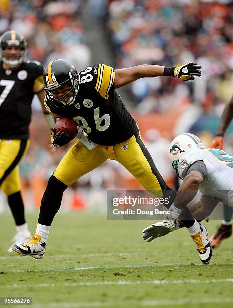 Wide receiver Hines Ward of the Pittsburgh Steelers avoids a tackle attempt by Akin Ayodele of the Miami Dolphins at Land Shark Stadium on January 3,...