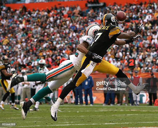 Wide receiver Mike Wallace of the Pittsburgh Steelers reaches out to try and catch a touchdown pass as the ball is knocked away by safety Jason Allen...