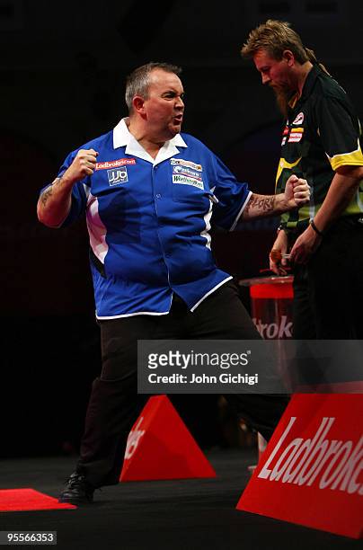 Phil Taylor of England celebrates winning a crucial set in the game against Simon Whitlock of Australia during the Final of the Ladbrokes.com World...