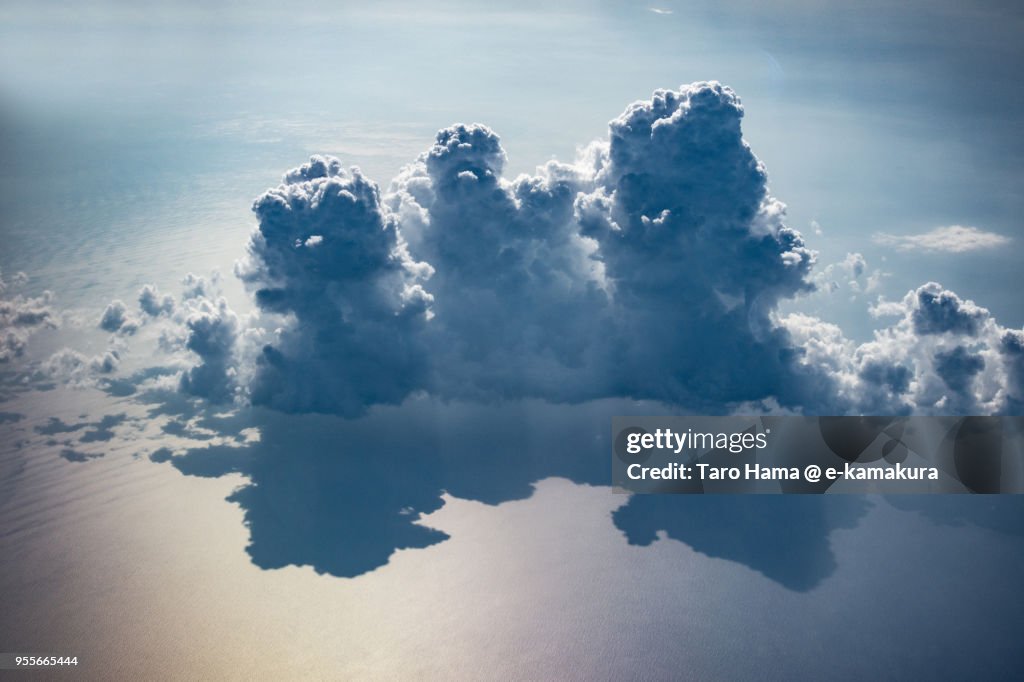 Thunder clouds on South China Sea daytime aerial view from airplane