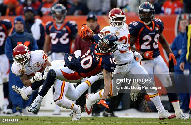 Wide receiver Jabar Gaffney of the Denver Broncos makes a first down reception as Ricky Price of the Kansas City Chiefs makes the tackle during NFL...