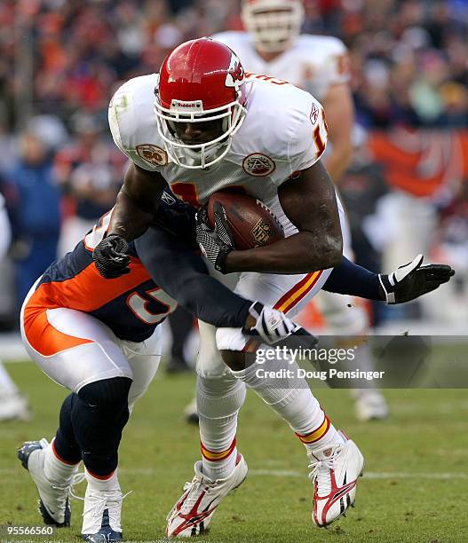 Chris Chambers of the Kansas City Chiefs makes a first down reception to the two yard line as D.J. Williams of the Denver Broncos makes the tackle...