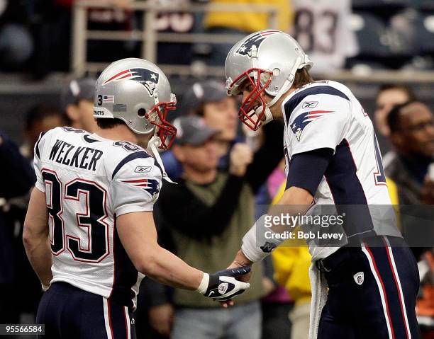 Quarterback Tom Brady and wide receiver Wes Welker of the New England Patriots chat during warm ups at Reliant Stadium on January 3, 2010 in Houston,...
