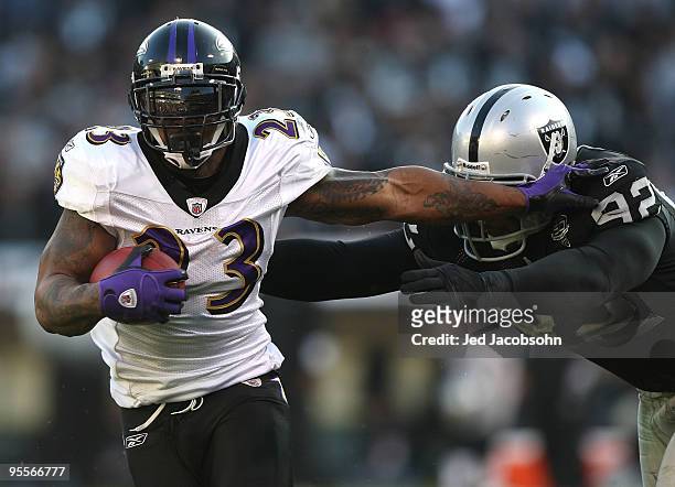 Willis McGahee of the Baltimore Ravens runs against Richard Seymour of the Oakland Raiders during an NFL game at Oakland-Alameda County Coliseum on...