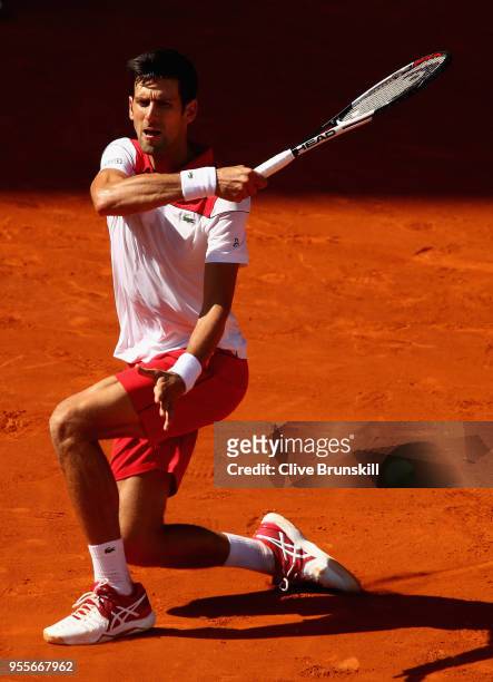Novak Djokovic of Serbia plays a forehand against Kei Nishikori of Japan in their first round match during day three of the Mutua Madrid Open tennis...