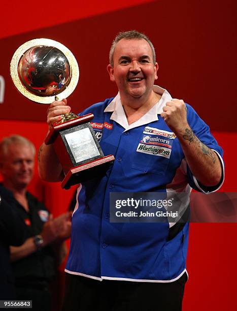 Phil Taylor of England holds his trophy for winning the world title for a record fifteenth time by beating Simon Whitlock of Australia in the final...