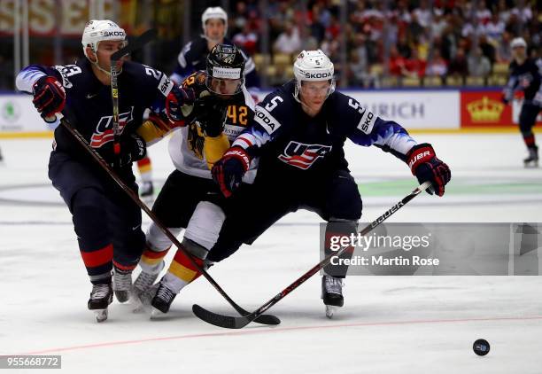 Alec Martinez and Connor Murphy of United States and Yasin Ehliz of Gemany battle for the puck during the 2018 IIHF Ice Hockey World Championship...