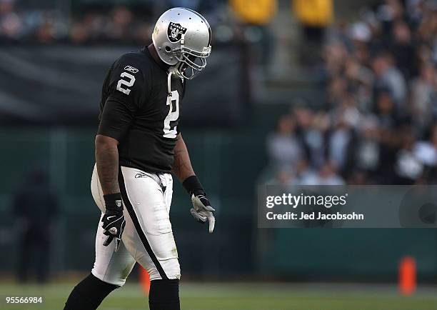 JaMarcus Russell of the Oakland Raiders walks off the field against the Baltimore Ravens during an NFL game at Oakland-Alameda County Coliseum on...