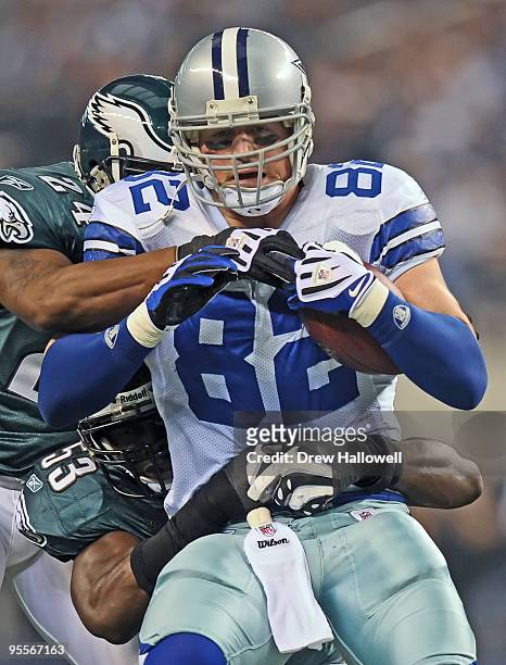 Tight end Jason Witten of the Dallas Cowboys gets tackled by linebacker Moise Fokou and cornerback Sheldon Brown of the Philadelphia Eagles on...