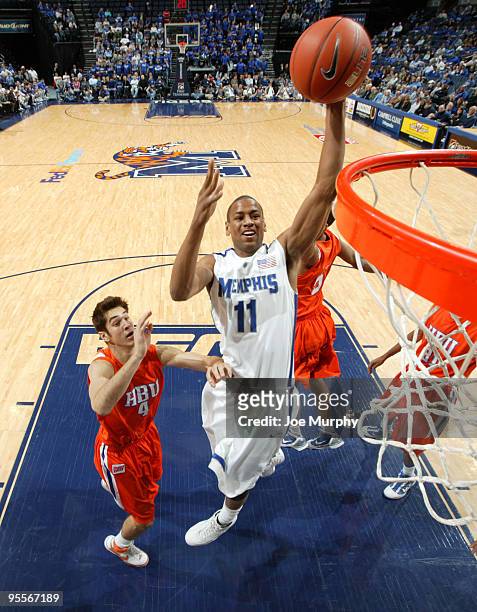 Wesley Witherspoon of the Memphis Tigers dunks the ball past Remy Boswell of the Houston Baptist Huskies on January 3, 2010 at FedExForum in Memphis,...