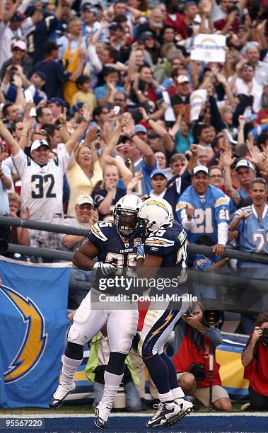 Fullback Mike Tolbert and running back Michael Bennett of the San Diego Chargers celebrate Tolbert's game-winning touchdown catch for the Chargers...