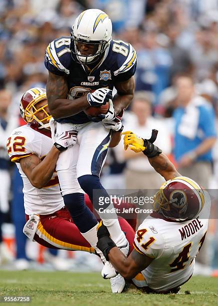 Kassim Osgood of the San Diego Chargers is brought down by Carlos Rogers and Kareem Moore of the Washington Redskins in the second half at Qualcomm...