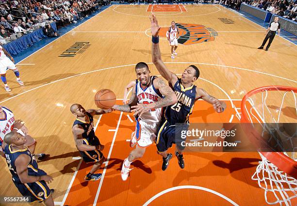 Wilson Chandler of the New York Knicks shoots against Brandon Rush of the Indiana Pacers during the game on January 3, 2010 at Madison Square Garden...