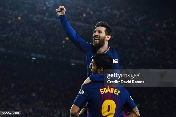 Lionel Messi of FC Barcelona celebrates with his team mate Luis Suarez after scoring his team's second goal during the La Liga match between...