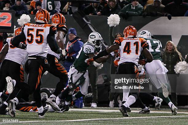 Wide receiver Jerricho Cotchery of the New York Jets scores a touchdown in the second quarter against Chinedum Ndukwe of the Cincinnati Bengals at...