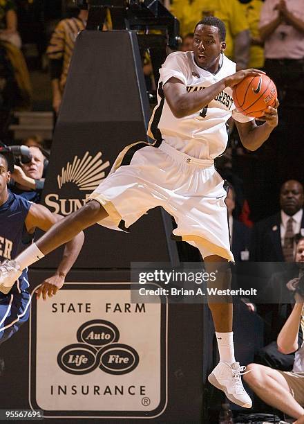 Al-Farouq Aminu of the Wake Forest Demon Deacons grabs one of his game high 18 rebounds against the Xavier Musketeers in the innaugural Skip Prosser...