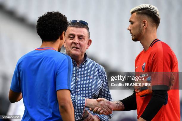 President of Les Herbiers, Michel Landreau speaks with Paris Saint-Germain's Brazilian defender Marquinhos during a training session at the Stade de...