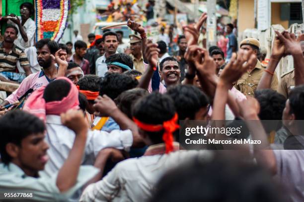 People dancing and performing music during the Ganesh Chaturthi celebration. Clay sculptures representing Ganesha are carried to the river or ocean...