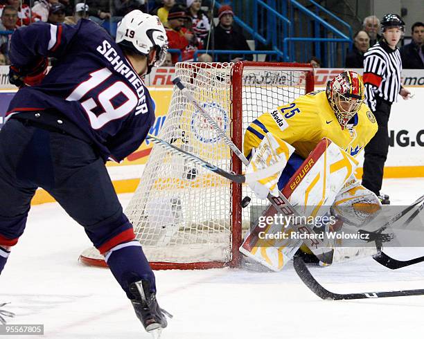 Jacob Markstrom of Team Sweden stops the puck on a shot by Jordan Schroeder of Team USA during the 2010 IIHF World Junior Championship Tournament...