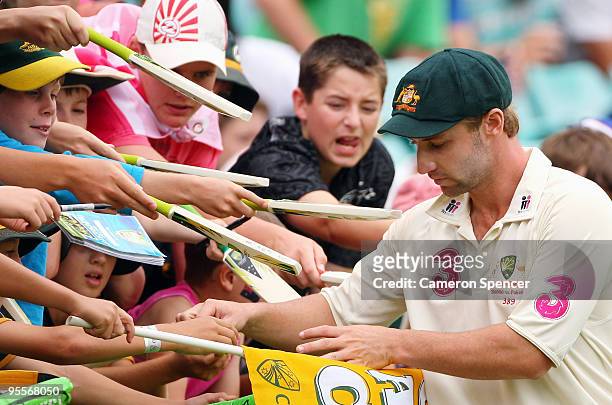 Phillip Hughes of Australia signs autographs during day two of the Second Test match between Australia and Pakistan at the Sydney Cricket Ground on...