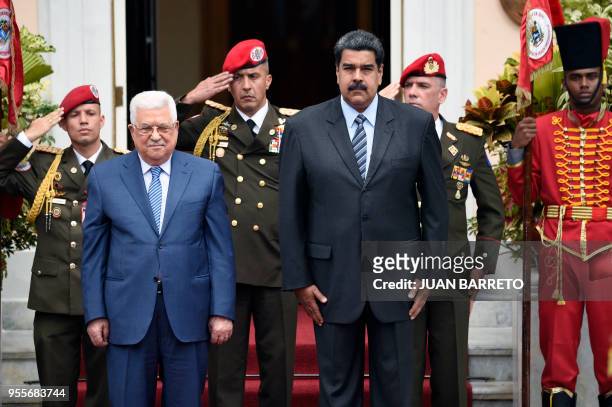 Venezuelan President Nicolas Maduro and Palestinian President Mahmud Abbas, are pictured during Abbas' welcome ceremony at the Miraflores...