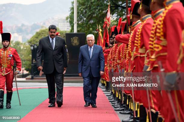 Venezuelan President Nicolas Maduro and Palestinian President Mahmud Abbas, review the honour guard at the Miraflores presidential palace in Caracas...
