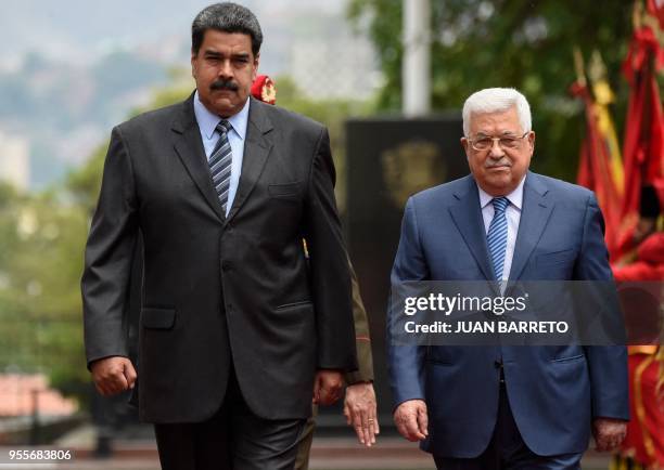 Venezuelan President Nicolas Maduro and Palestinian President Mahmud Abbas, review the honour guard at the Miraflores presidential palace in Caracas...