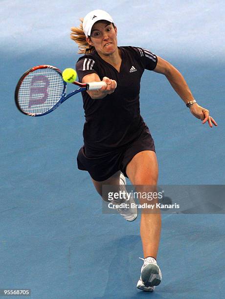 Justine Henin of Belgium plays a forehand in her first round match against Nadia Petrova of Russia during day two of the Brisbane International 2010...