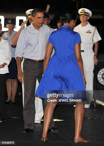 President Barack Obama and first lady Michelle Obama prepare to board Air Force One at Hickam Air Force Base in Honolulu, Hawaii, on January 3, 2010....