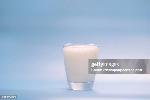 milk on a blue background,milk,milk bottle,milk glass - milk glass stock pictures, royalty-free photos & images