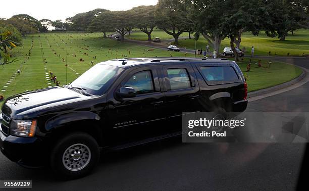 Reuters White House Correspondent Jeff Mason is seen reflected in the window of the pool bus as US President Barack Obama's motorcade rolls by at...