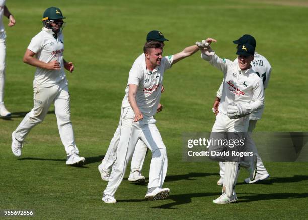 Jake Ball of Nottinghamshire celebrates with team mates after taking the wicket of Kyle Abbott during day four of the Specsavers County Championship...