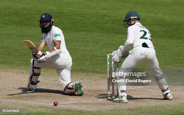 Hashim Amla of Hampshire sweeps the ball during day four of the Specsavers County Championship Division One match between Nottinghamshire and...