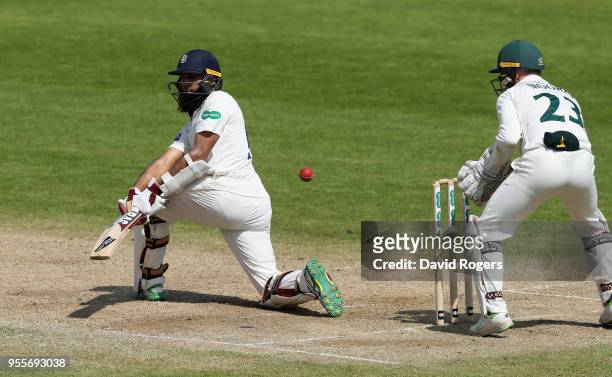 Hashim Amla of Hampshire sweeps the ball during day four of the Specsavers County Championship Division One match between Nottinghamshire and...
