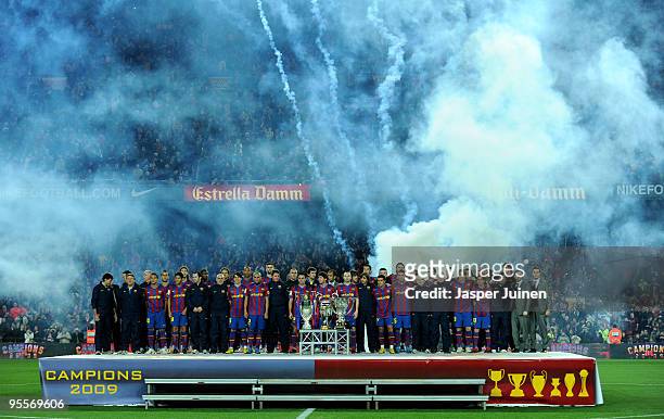 Barcelona players pose with the 2008�09 La Liga, Copa del Rey, Supercopa, Champions League, UEFA Super Cup and the FIFA Club World Cup trophies prior...