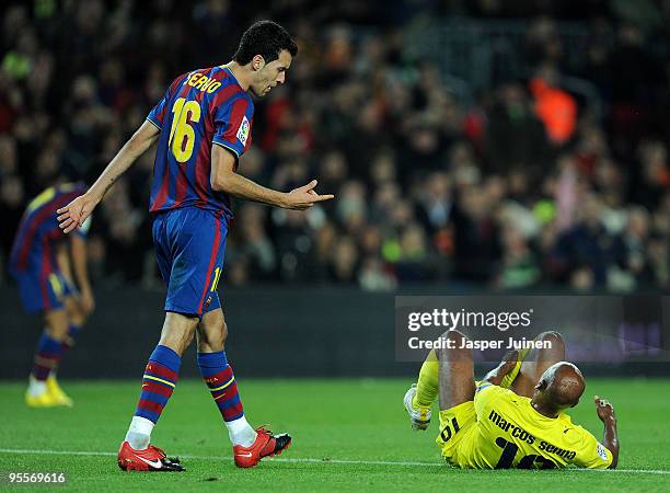 Sergio Busquets of FC Barcelona reacts to Marcos Senna of Villarreal during the La Liga match between Barcelona and Villarreal at the Camp Nou...