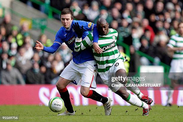 Celtic's French striker Marc-Antoine Fortune vies with Rangers Danny Wilson during a Scottish Premier League football match at Celtic Park, Glasgow,...