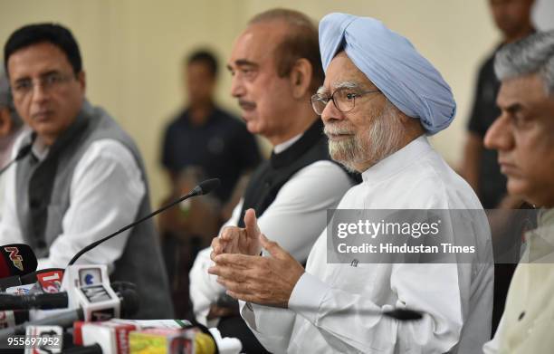 Former Prime Minister of India, Manmohan Singh with Congress spokesperson Randeep Surjewala and Ghulam Nabi Azad, the leader of the Opposition in...