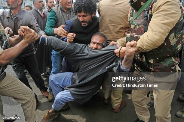 Police detain supporters of independent MLA Er Sheikh Abdul Rashid during a protest against recent civilian deaths on May 7, 2018 in Srinagar, India....