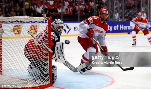 Curtis McElhinney, goaltender of Canada makes a save on Nichlas Hardt of Denmark during the 2018 IIHF Ice Hockey World Championship group stage game...